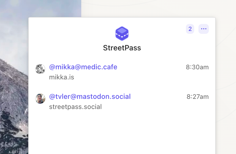 The main focus of the image is the StreetPass app interface, which displays user accounts in the fediverse.